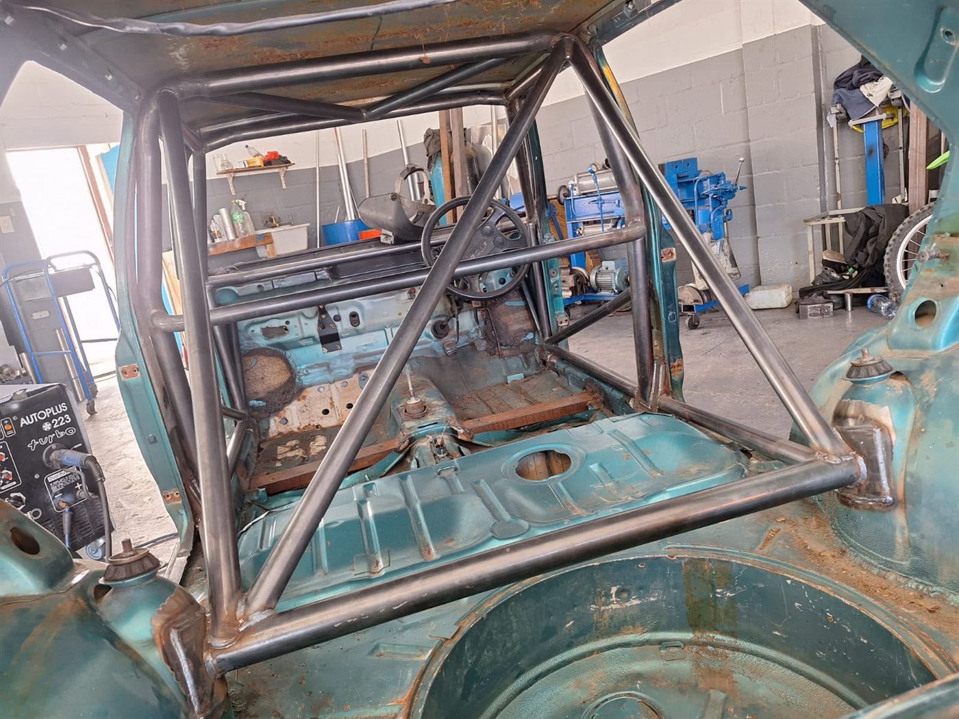 Roll cage frame welded into a bare shell