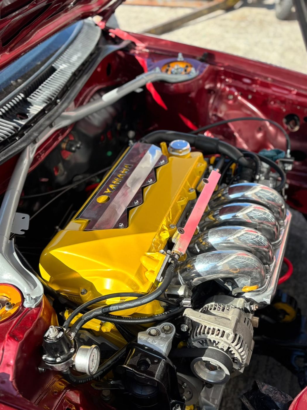 Twin-cam engine conversion in a maroon car